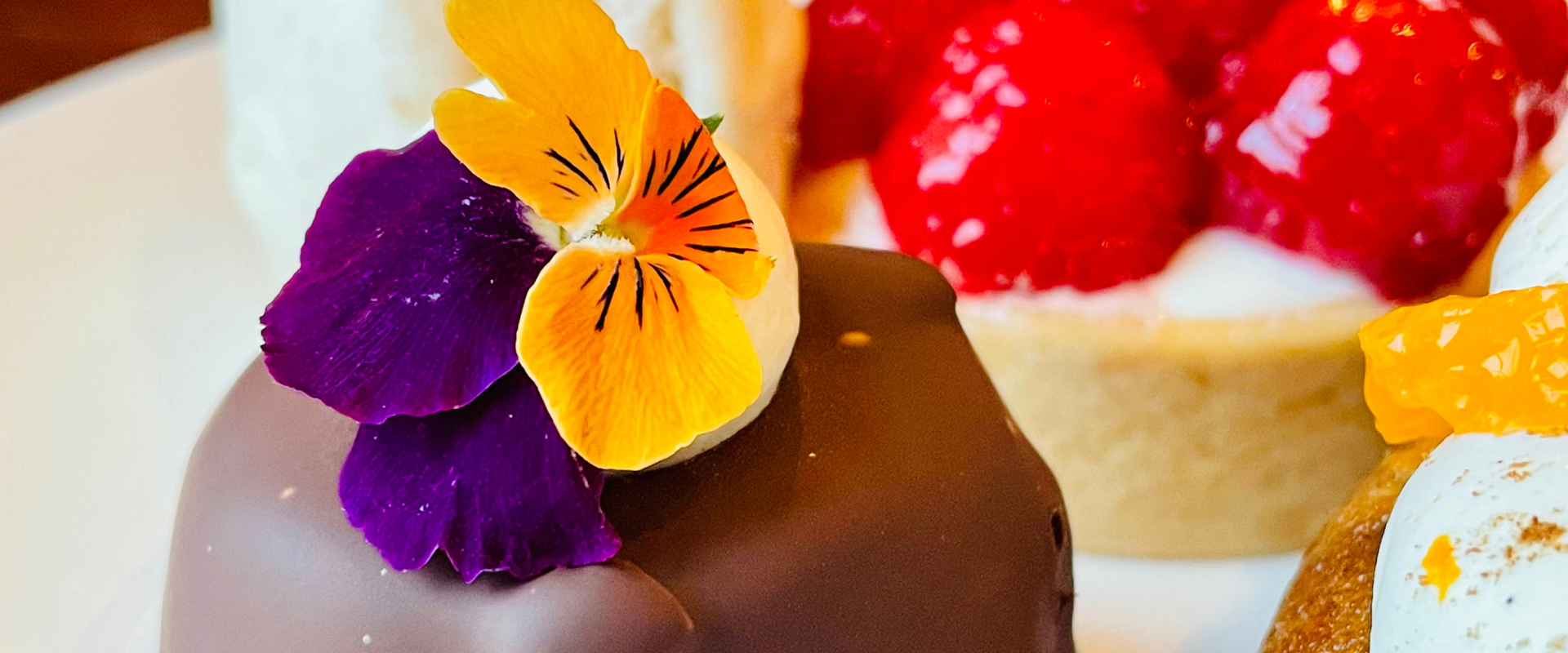 Image of chocolate treat next to a raspberry tart